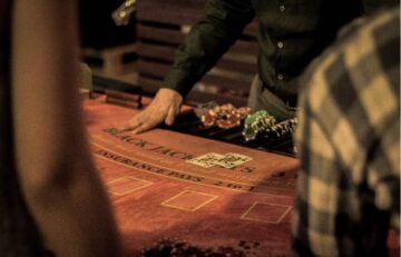 A blackjack table with a dealer